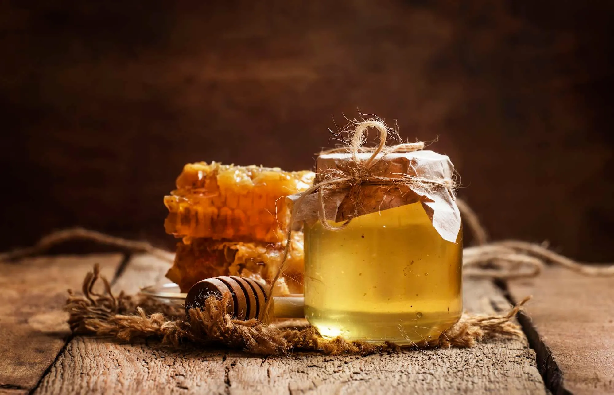 Jar of honey and honeycomb on a table